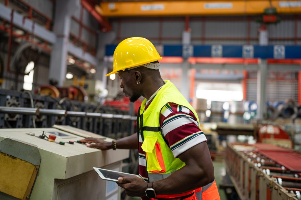 male engineer using tablet Monitoring Production Conveyor.